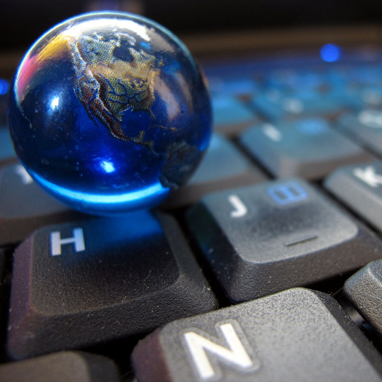 A picture of a globe on a keyboard.
